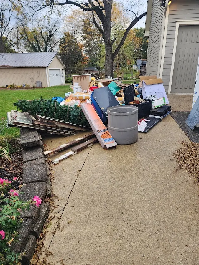 Dumpster being loaded with debris for Estate Cleanout Dumpster Rental in Thomasville